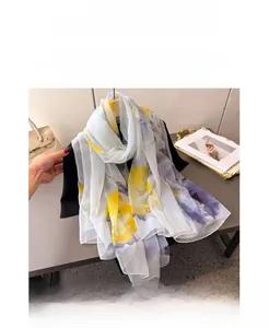 Detail of light printed chiffon scarf with abstract floral pattern and soft texture