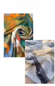Detailed view of lightweight printed silk scarf featuring vibrant tropical patterns and textures