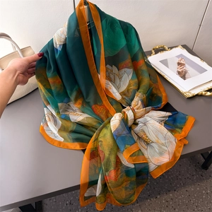 Lightweight dark green floral shawl with orange lotus print and rolled edges