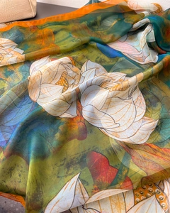 Close-up of translucent floral silk scarf featuring vintage lotus art and smooth texture
