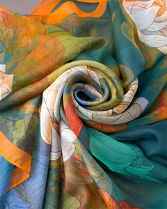 Detail of floral print silk scarf featuring lotus patterns and fine stitched edges