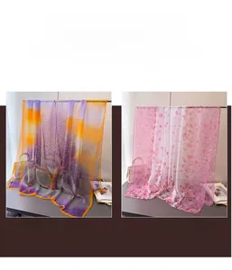 Detail view of floral print silk scarves in purple and pink chiffon fabric