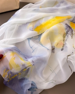 Detailed macro shot of printed chiffon scarf fabric showing airy texture and floral patterns