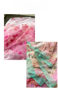 Detailed view of floral print chiffon scarves in pink and green botanical patterns