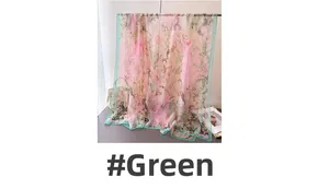 Detail of pink floral chiffon scarf with green borders and delicate flower patterns