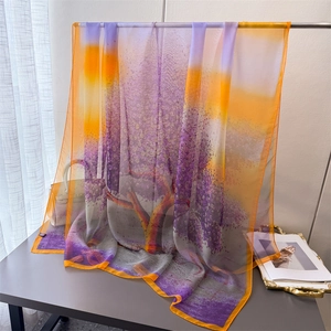 Close-up of lightweight floral print scarf with elegant purple and orange gradient patterns