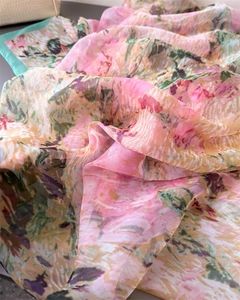 Close-up of semi-transparent floral print silk scarf with mint green edge detail