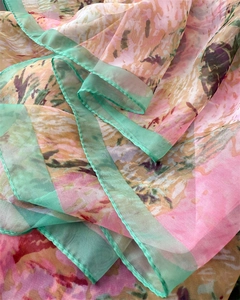 Detail of floral print silk scarf showing soft semi-transparent chiffon fabric texture