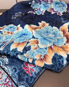 Macro shot of silk scarf showing peony floral patterns and delicate silk texture