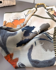 Close-up of herringbone weave texture and floral print on premium silk feel scarf