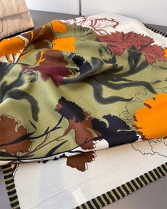 Close-up of floral cotton-linen feel silk scarf with vintage pattern and striped border