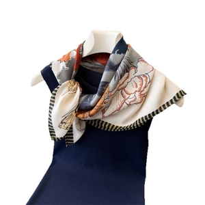 Floral cotton linen square scarf with vintage orange and grey print on a model stand