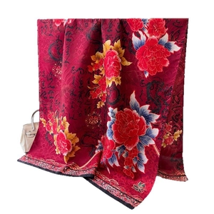 Silk scarf featuring red peony print and artistic calligraphy with dragon patterns