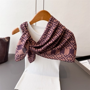 Classic double F pattern silk scarf in brown, styled on a wooden hanger with white top