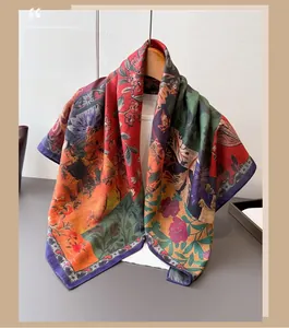 Detailed view of vintage floral silk scarf with green and orange patterns on a wooden hanger