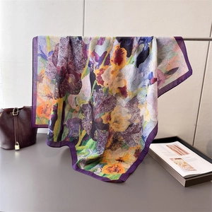 Double-sided herringbone silk scarf featuring vibrant iris flower print and purple borders