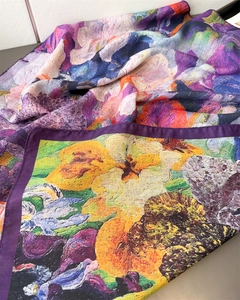 Detail of vibrant floral print scarf with purple hem and premium silk-like texture