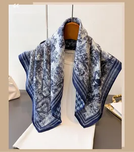 Detailed close-up of blue Toile de Jouy silk scarf with houndstooth pattern border