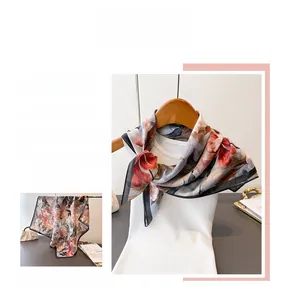 Close-up of elegant double-sided silk scarf featuring vintage floral pattern on white model