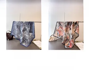 Detail view of double-sided silk scarves featuring jungle and floral patterns