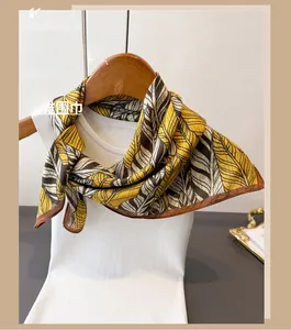 Detailed texture of double-sided silk scarf with yellow and grey herringbone pattern