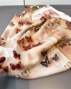 Close-up detail of double-sided butterfly silk scarf with elegant herringbone pattern