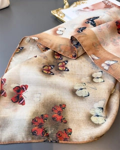 Detailed view of lightweight butterfly print silk scarf with refined herringbone texture