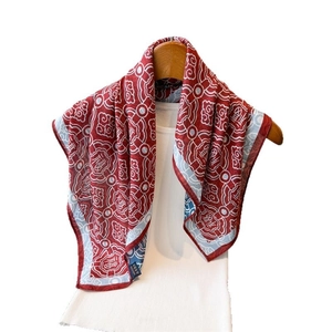 Red silk scarf with white Chinese auspicious clouds and Fu character design on wooden hanger