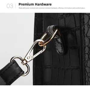 Macro detail of glossy light gold metal hook on black crocodile pattern shoulder bag