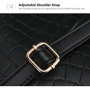 Detailed close-up of adjustable strap and golden buckle on black crocodile pattern bag