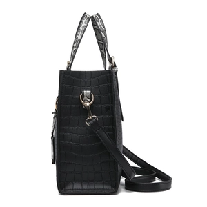 Fashionable black faux crocodile skin bucket bag with snake print handles and gold hardware