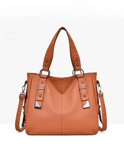 Detailed front view of amber PU leather tote bag with silver metal ring and rivets