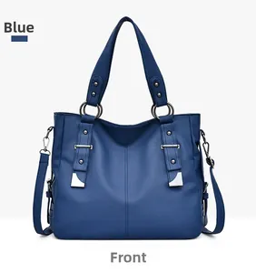 Detailed front view of dark blue pebbled leather handbag with silver hardware accents