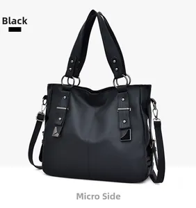 Close-up of black litchi grain PU leather bag with silver rings and rivet details
