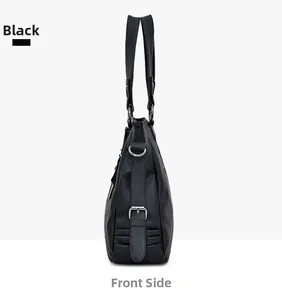 Side view of a black pebble textured PU leather tote bag with silver metal D-ring buckle