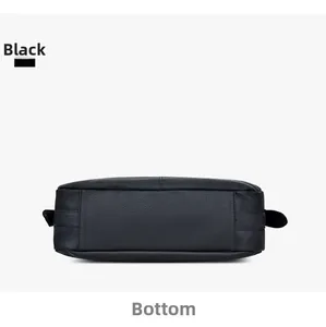 Detailed bottom view of black lychee grain leather handbag with stitching details