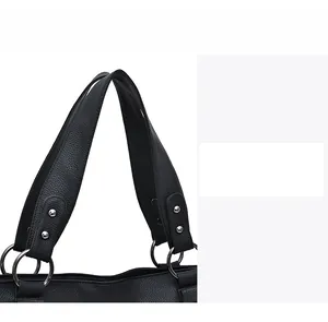 Detail of lychee pattern leather handbag with silver metal rings and rivets