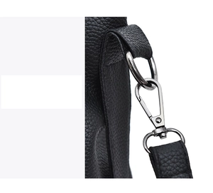 Detail of black pebbled leather handbag with silver D-ring and lobster clasp hardware