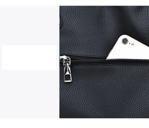 Close-up of black lychee grain leather crossbody bag with a white smartphone in the zipper pocket