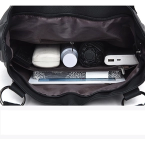 Spacious interior of black leather tote bag with multiple compartments and pockets