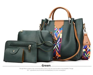 Detail of 4-piece dark green leather handbag set with colorful ribbon strap and gold hardware