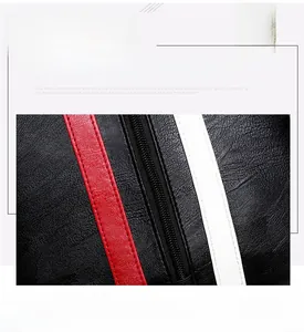 Detail of black lychee grain leather bag featuring red and white contrast stripes