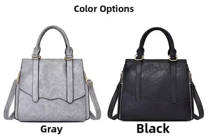 Detail view of large capacity PU leather handbags in grey and black with wave-edge flaps