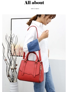 Chic red tote bag with ring handle shown with a model in a minimalist setting