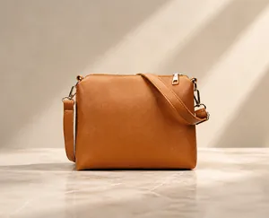 Close-up of brown litchi pattern leather shoulder bag with gold zipper and metal buckle