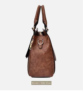 Side view detail of large brown leather tote bag with gold hardware and fine stitching
