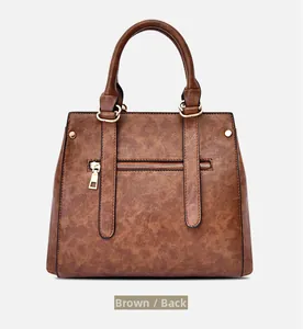 Rear view of brown leather tote bag featuring a practical zip pocket and gold hardware
