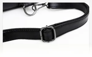 Detail of black leather bag strap with gunmetal adjustment buckle and fine stitching