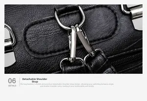 Detail of silver metal hook and detachable strap on black pebbled leather handbag