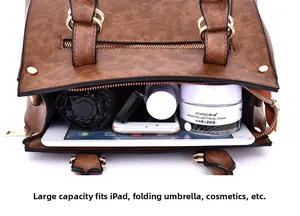 Detailed view of the large capacity interior of this vintage brown faux leather handbag